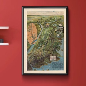 May include: A framed vintage map of a city, with a detailed illustration and a black frame. The map is displayed on a red wall, with white shelves holding decorative items. The room has a wooden floor.