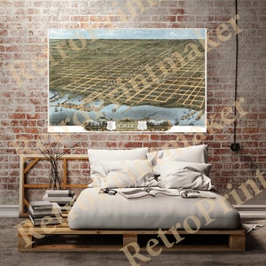 May include: An antique map of Erie, Pennsylvania, showing the city's layout and surrounding area. The map is printed in shades of brown, green, and blue, with the city's name prominently displayed in a banner at the bottom.