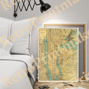 May include: A vintage map of Manhattan, New York City, with a light blue and green color scheme. The map is framed and hanging on a wall above a white bed with a white headboard.