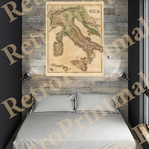 May include: A vintage map of Italy, printed in brown, green, and yellow, with the word "ITALY" in the top right corner. The map is framed and hanging on a wood wall.