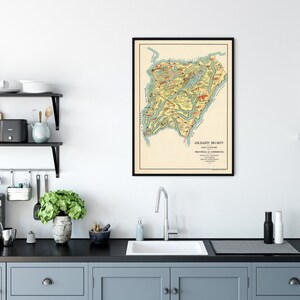 May include: A vintage map of the "Colección Brujas" region of Santa Eulalia, Provincia de Corrientes, Argentina. The map is framed in a black frame and hangs on a white wall above a kitchen counter.