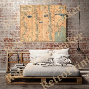 May include: A vintage map of the Mississippi River Valley and its fortifications. The map is printed on paper and has a light brown background with blue and black lines. The map is framed and hanging on a brick wall.