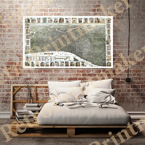 May include: A vintage map of the city of Grand Rapids, Michigan, printed in black and white with colored accents. The map shows the city's streets, buildings, and landmarks. The map is framed and hanging on a brick wall.