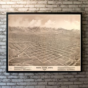 May include: A vintage black and white aerial view map of Salt Lake City, Utah. The map shows the city's layout with streets, buildings, and surrounding mountains. The text "Bird's-eye View of Salt Lake City, Utah, 1885" is printed at the bottom of the map.