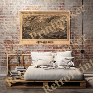 May include: An antique map of Ithaca, New York, printed in brown ink on a cream-colored background. The map shows the city's streets, buildings, and landmarks, including a large oval-shaped park in the center. The map is titled "Ithaca, N.Y. 1883."