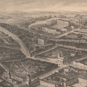 May include: An aerial view of a city with a large building in the center. The building has a tall spire and is surrounded by smaller buildings. The city is laid out in a grid pattern with streets running in all directions.