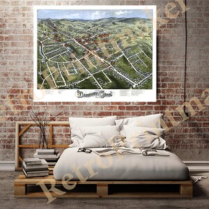 May include: An antique, hand-coloured map of Danbury, Connecticut, showing the town's layout and streets in detail. The map is printed on paper and has a vintage aesthetic.