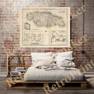 May include: An antique map of Jamaica, printed in black and white on a cream-colored background. The map shows the island's coastline, rivers, and towns. The map is surrounded by a decorative border.