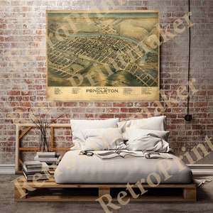 May include: An antique map of Pendleton, Umatilla County, Oregon. The map shows the town's layout with streets, buildings, and a river. The map is printed in brown, green, and black ink on a cream-coloured paper.