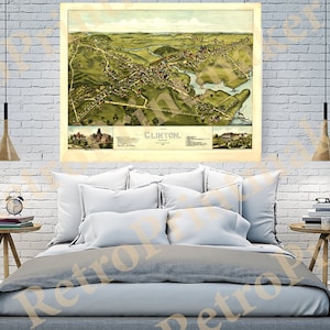 May include: An antique map of Clinton, Massachusetts, printed in 1884. The map shows the town's streets, buildings, and waterways in a detailed, bird's-eye view. The map is printed in shades of brown, green, and blue.