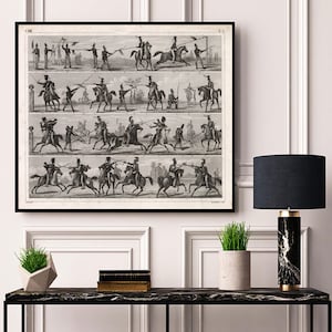 May include: A black and white vintage illustration of soldiers on horseback practicing sword fighting. The illustration is divided into four sections, each showing a different stage of the sword fight. The illustration is framed in a black frame and is hanging on a white wall.
