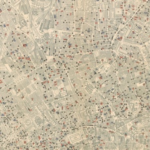 May include: A detailed map of London, England, with red crosses marking locations throughout the city. The map is printed on a cream-colored paper and includes street names and other details.