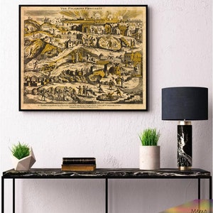 May include: A framed print of "The Pilgrim's Progress" map in black and gold tones. The print is displayed above a black marble table with a black lamp and two small potted plants. The text "The Pilgrim's Progress" is visible at the top of the print.