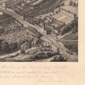 May include: A black and white engraving of a bird's eye view of the University of Oxford, England. The engraving shows the buildings and grounds of the university, including the Radcliffe Camera, the Bodleian Library, and the Sheldonian Theatre. The engraving is dated 1800.