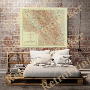 May include: Vintage map of Glacier National Park in Montana, USA. The map shows the park's boundaries, roads, trails, and elevation contours. The map is printed on a cream-colored paper with brown and red lines.