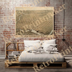 May include: An antique map of Jefferson, Texas, printed in 1875. The map shows the city's streets, buildings, and waterways. The map is in a vintage style with a brown and beige color scheme.