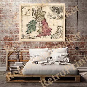 May include: An antique map of Great Britain and Ireland, printed on aged paper with a faded, cream background. The map is framed and hanging on a brick wall above a bed with white linens.