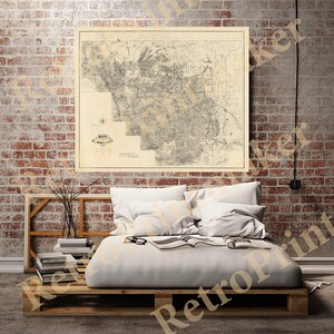 May include: A vintage map of St. Louis County, Missouri, printed on aged paper with a brown background. The map shows the county's roads, rivers, and towns. The map is framed and hanging on a brick wall.