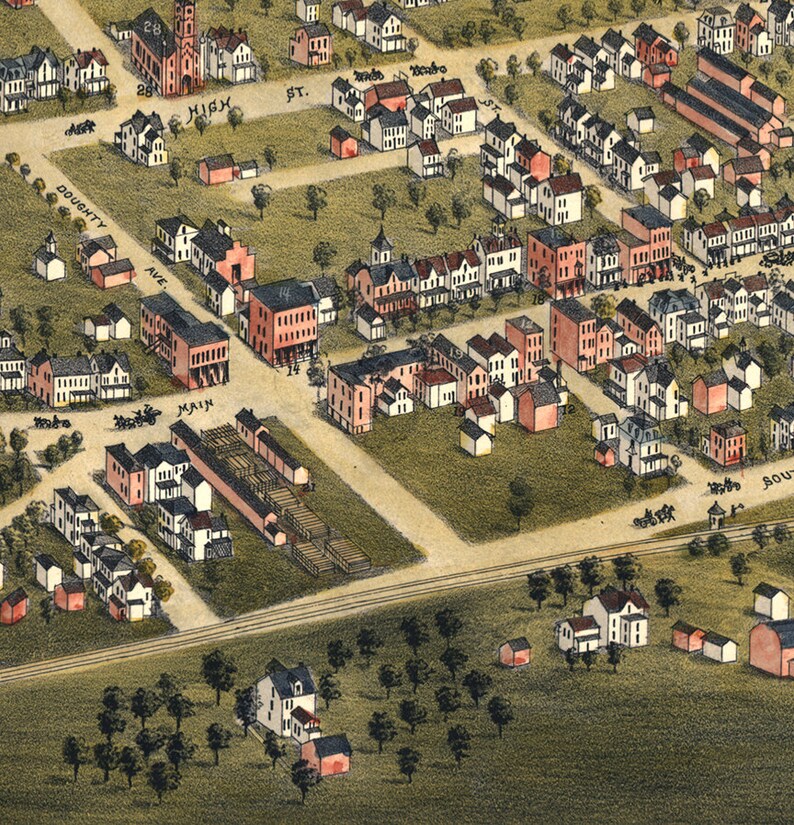 May include: An aerial view of a town with a grid of streets and houses. The streets are lined with trees and the houses are mostly two-story with red roofs. The town is surrounded by a field of green grass.