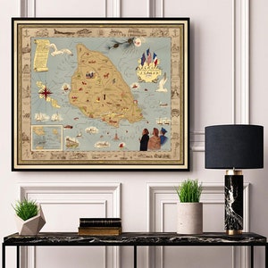 May include: A vintage map of Mackinac Island, Michigan, with a blue and white color scheme. The map shows the island's landmarks, including the Grand Hotel, the Mackinac Bridge, and the Straits of Mackinac. The map is framed in a black frame and is hanging on a white wall.