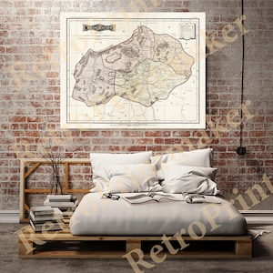 May include: An antique map of Aguascalientes, Mexico, printed on paper with a cream background. The map shows the different regions of the state, including the capital city of Aguascalientes. The map is framed and hanging on a brick wall.