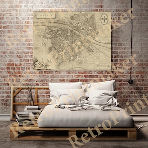 May include: A vintage map of Florence, Italy, printed on canvas and hanging on a brick wall above a bed with white bedding. The map shows the city's streets and landmarks.