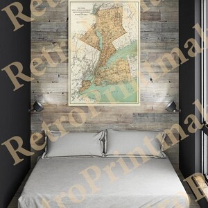 May include: A vintage map of New York State, showing counties and major cities. The map is printed on paper and has a light brown background with green and yellow accents. The map is framed and hanging on a wall in a room with a wooden floor and a bed.