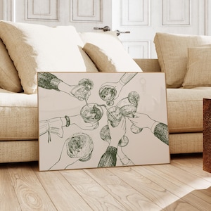 May include: A framed artwork featuring a pen and ink illustration of hands toasting with glasses. The artwork has a neutral color palette with a beige background and dark green line art. The artwork is displayed on a wooden floor.
