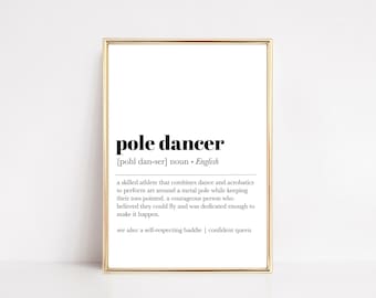 May include: A framed print with a gold border features the definition of "pole dancer" in black text on a white background. The definition includes the pronunciation, part of speech, and a description of the activity.