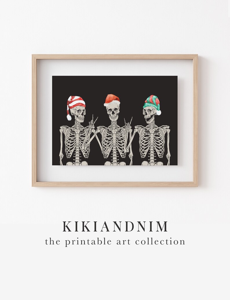 May include: A framed print featuring three skeletons against a black background. The skeletons wear festive hats in red, white, and green, with hand gestures including peace signs and rock-and-roll signals. The text KIKIANDNIM the printable art collection appears below.