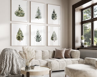 May include: A set of six framed wall art prints featuring watercolor illustrations of various evergreen trees in shades of green, displayed in a grid pattern above a beige tufted sofa with a chunky knit throw blanket and a round coffee table.