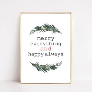 May include: A framed print with a gold border features the text "merry everything and happy always" in black and red. Watercolor sprigs of evergreen branches are above and below the text, creating a festive holiday theme.