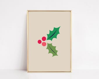 May include: A framed wall art print featuring a graphic illustration of holly leaves and berries. The design includes one dark green leaf, one light green leaf, and three circular berries in shades of red and pink on a beige background.