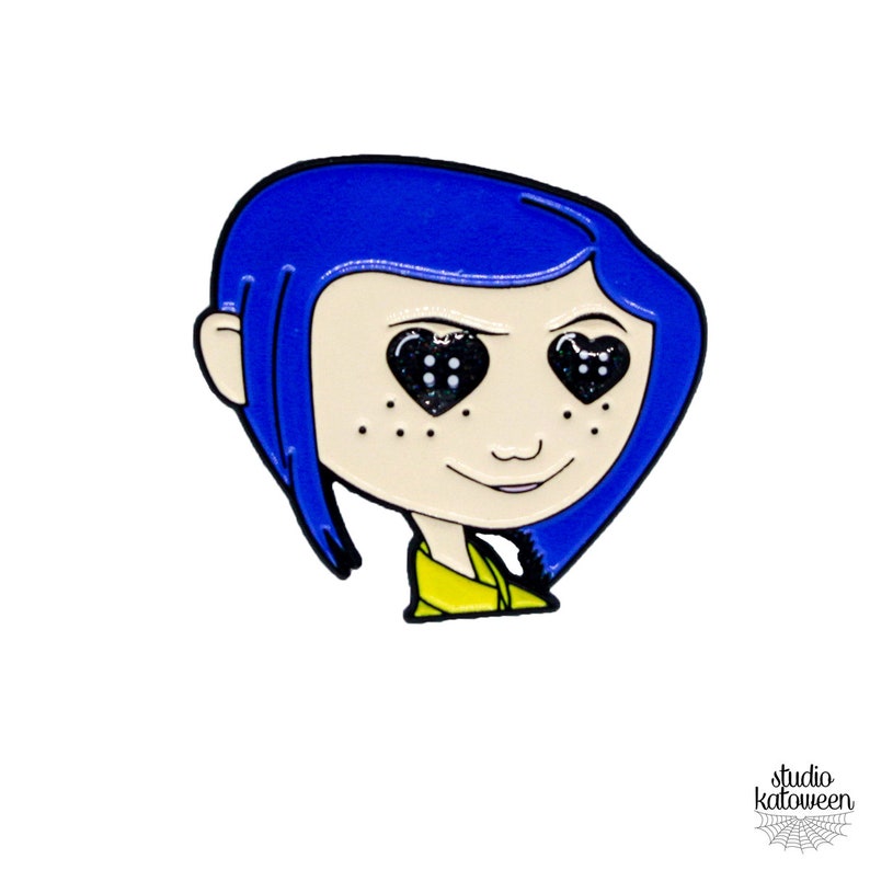 May include: A pin featuring a cartoon character with blue hair and heart-shaped eyes filled with black glitter. The character has freckles and is wearing a yellow shirt. The pin is outlined in black.