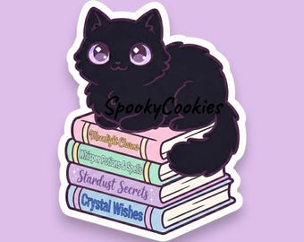 May include: A sticker featuring a black cat with large purple eyes sitting atop a stack of books. The books are titled "Moonlight Charms", "Whisper Potions & Spells", "Stardust Secrets", and "Crystal Wishes". The sticker has the text "SpookyCookies".