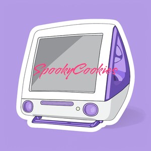 May include: A white and purple vintage Apple computer with a sticker that says "SpookyCookies" on the screen.