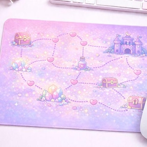 May include: A pastel-colored mousepad featuring a whimsical map design. The map includes a castle, treasure chests, crystals, and a potion bottle, all connected by a dotted line of hearts. The color palette is primarily pink and purple.
