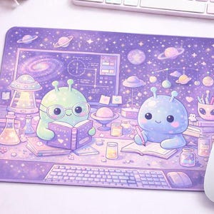 May include: A purple mousepad featuring a whimsical space-themed design. Two cartoon aliens are depicted studying and writing, surrounded by planets, stars, and scientific equipment. The mousepad includes a keyboard and a computer screen.