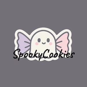 May include: A white ghost-shaped candy with a smiling face and pink cheeks, wrapped in purple and pink candy wrappers. The text "SpookyCookies" is written in black cursive below the candy.