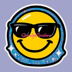 May include: A yellow smiley face sticker wearing black sunglasses. The sticker has a blue glitter border and the text "Spooky Cookies" in pink cursive. Two white starbursts are on the sticker.