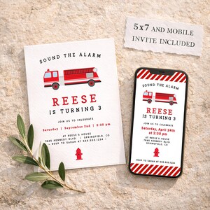 May include: A white invitation and a smartphone show a birthday party invitation with a red fire engine graphic. The text reads "Sound the Alarm" and "Reese is turning 3." The invitation includes event details.