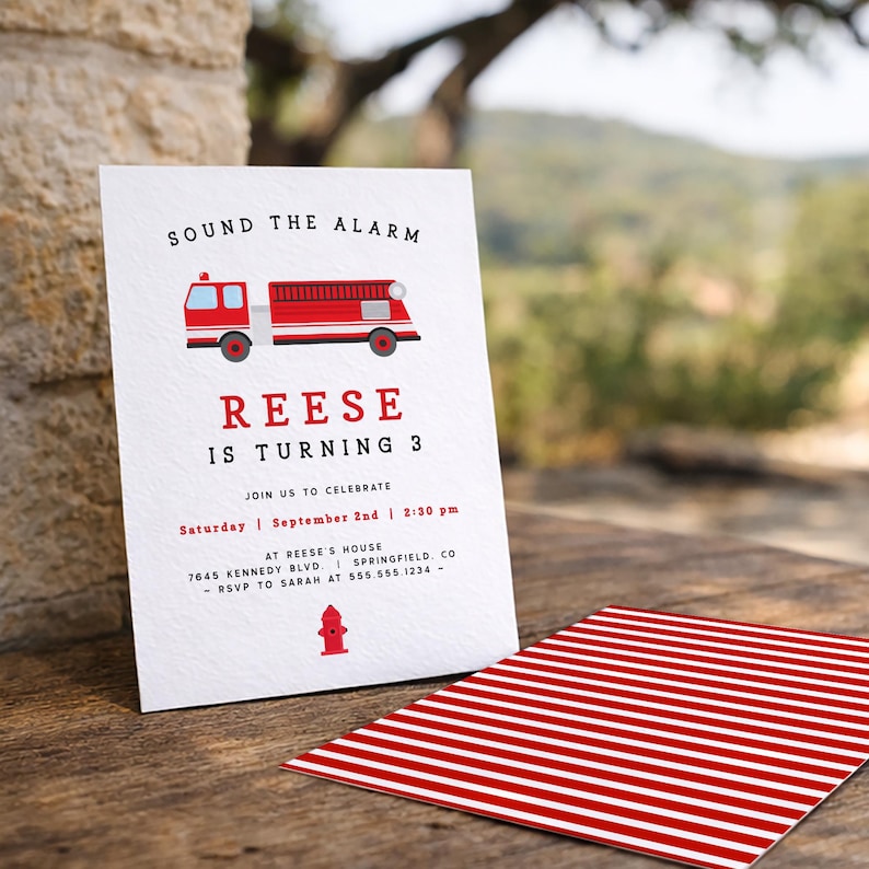 May include: A white invitation card featuring a red fire engine illustration and the words "SOUND THE ALARM". The text announces "REESE IS TURNING 3" with event details. A red and white striped card is also visible.