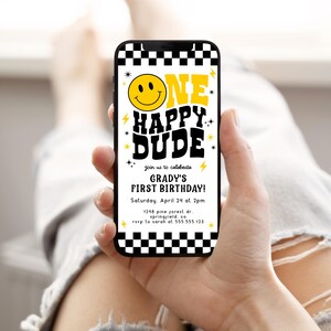 May include: A smartphone displays a birthday invitation with a retro design. The invitation reads "ONE HAPPY DUDE" with a smiley face and lightning bolt accents. The text also includes the birthday boy's name, date, time, and location.