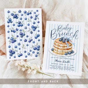 May include: Two rectangular invitation cards with a light blue vertical striped background. The left card features a repeating blueberry pattern. The right card displays a stack of pancakes with blueberries and a blue ribbon, with text reading Baby Brunch.