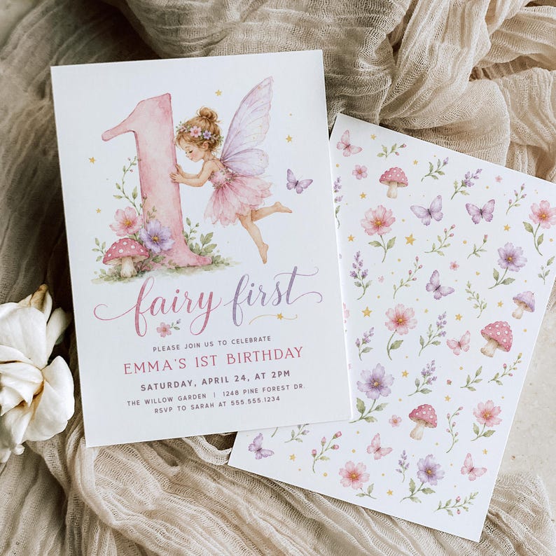 May include: A white birthday invitation card featuring a large pink number one, a fairy with purple wings, mushrooms, and flowers. The text reads: fairy first, PLEASE JOIN US TO CELEBRATE EMMA'S 1ST BIRTHDAY, SATURDAY, APRIL 24, AT 2PM, THE WILLOW GARDEN.