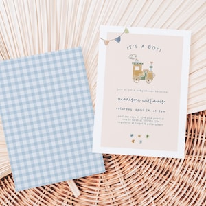May include: A baby shower invitation with a light blue and white gingham pattern background. The invitation features a cartoon train with a banner that reads "It's a Boy!" and the text "Join us for a baby shower honoring Madison Williams, Saturday, April 24, at 2pm. Post Oak Cafe, 1248 Pine Forest Dr. RSVP to Sarah at 555-555-1234. Registered at Target & Pottery Barn."
