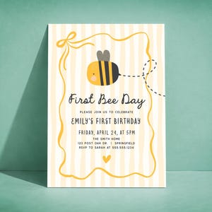 May include: A First Bee Day invitation with a cartoon bee illustration. The invitation has a yellow and white striped background with a yellow border. Text includes "First Bee Day" and details for Emily's first birthday.