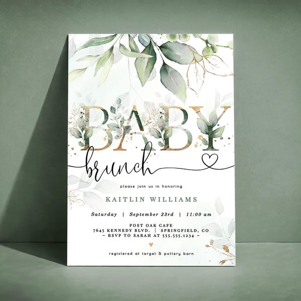 Puede incluir: Una invitación blanca con las palabras "BABY brunch" en oro y fuente manuscrita, adornada con vegetación de acuarela y detalles dorados. La invitación incluye detalles del evento y un símbolo de corazón.