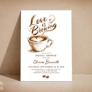 May include: A white rectangular bridal shower invitation card featuring a watercolor illustration of a coffee cup with latte art and the brown text Love is Brewing. The card includes details for Olivia Bennett on Saturday, September 24 at 5PM.