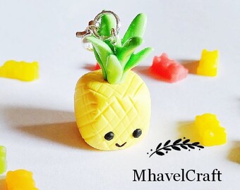May include: A yellow pineapple charm with a smiling face and green leaves, surrounded by colorful gummy bear candies. The charm has a silver-colored ring. The image includes the text "MhavelCraft".